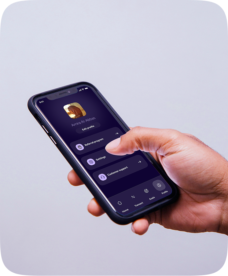 Profile screen held in hand showing referral, settings and support
